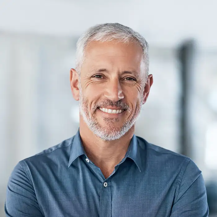mature man smiling indoors