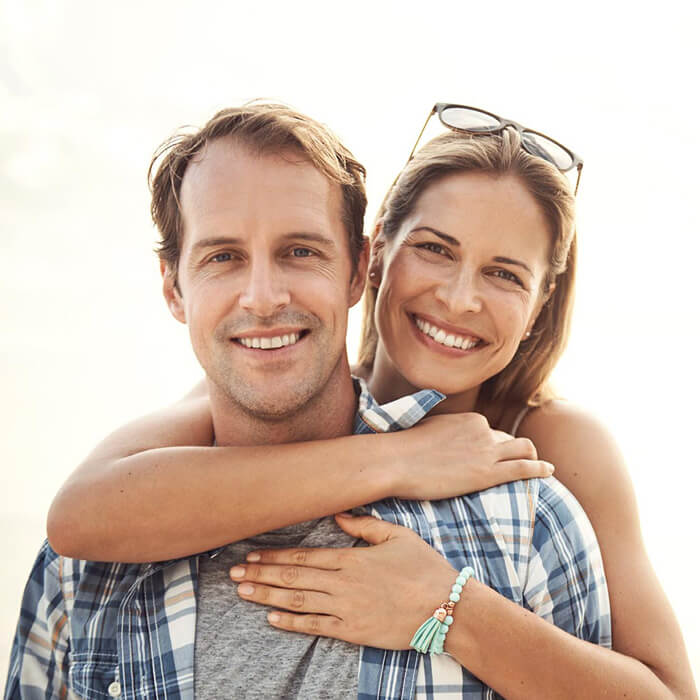 man and woman smiling together